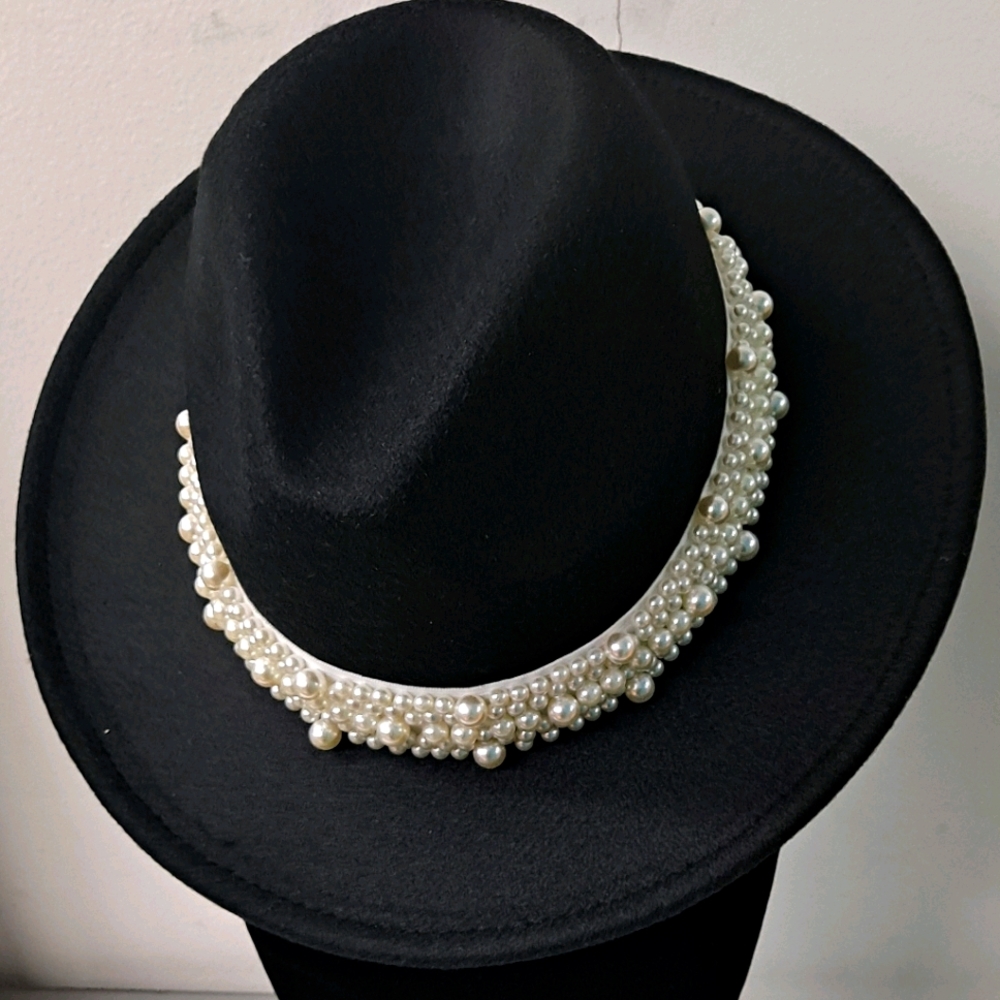 Black hat with faux pearl trim.